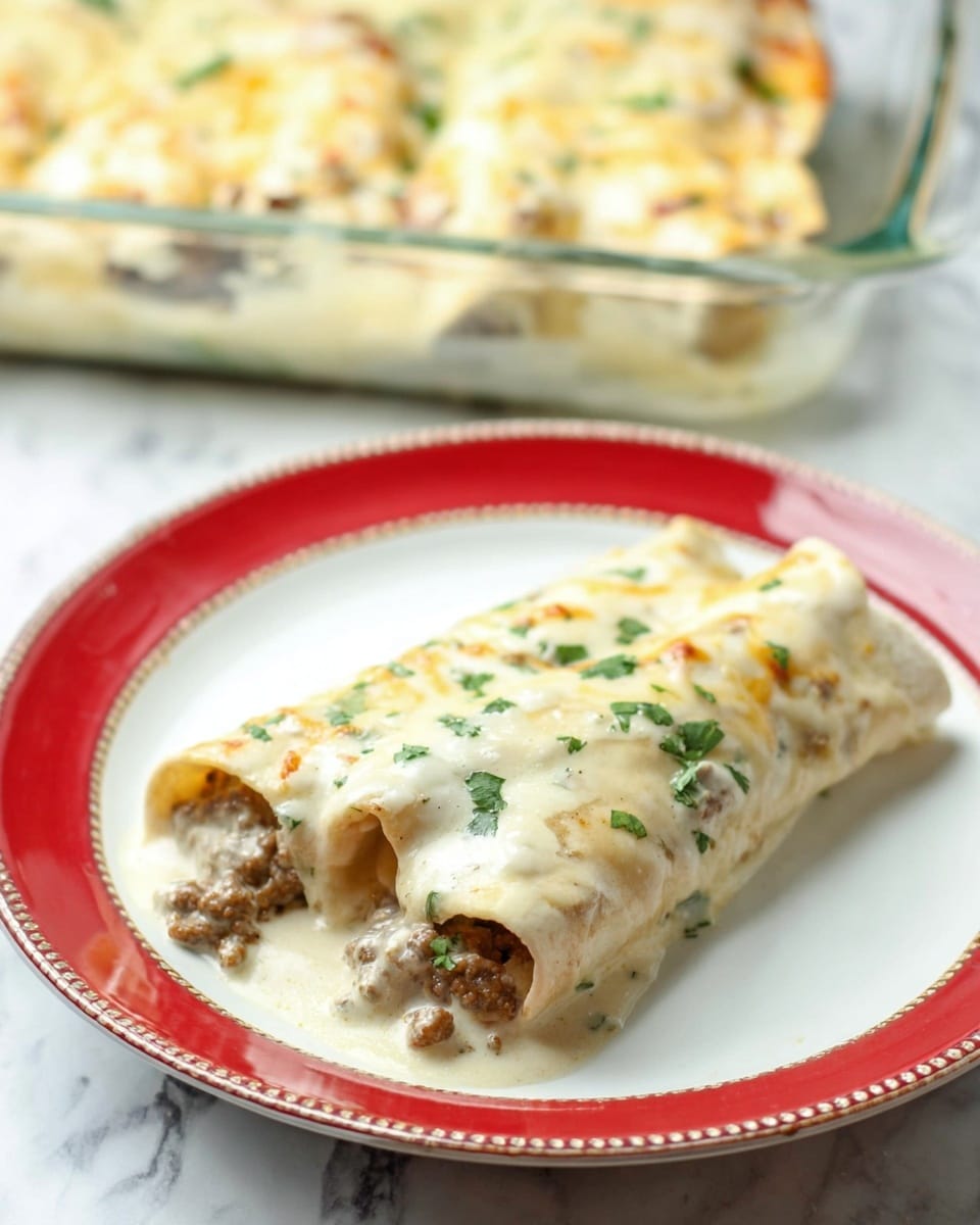 The image shows a glass baking dish filled with a creamy, white sauce layered casserole. The top layer is smooth and slightly browned in spots with small pieces of browned sausage spread throughout. Fresh green parsley leaves are sprinkled on top, adding a touch of color. The dish has partly been scooped out on one side with a metal spoon, exposing the thick, creamy layers beneath that blend together with bits of sausage. The background is a white marbled texture. photo taken with an iphone --ar 4:5 --v 7