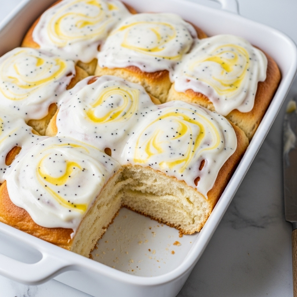 A white baking dish holds a baked dish cut into square pieces, with one piece slightly pulled out. The dish has several layers: the bottom layer is a thick, soft, golden-brown bread-like base with small bits of filling visible; the middle layer has patches of orange melted cheese mixed with brown bits of sausage; the top layer is a smooth, creamy white cheese sauce sprinkled lightly with black pepper. The edges of the dish show some browned, melted cheese, and the background is a white marbled surface. photo taken with an iphone --ar 4:5 --v 7
