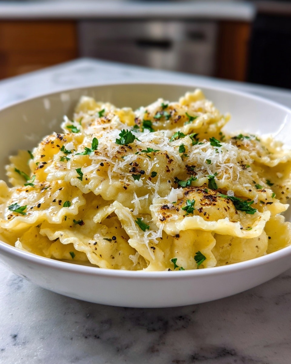 A white bowl filled with layered pasta that is pale yellow and soft with ruffled edges. The top layer is lightly browned with small charred spots, sprinkled evenly with finely grated white cheese and small green herb leaves, likely parsley. Small black pepper bits scatter the top, adding texture. The bowl sits on a white marbled surface with a blurred kitchen background. photo taken with an iphone --ar 4:5 --v 7