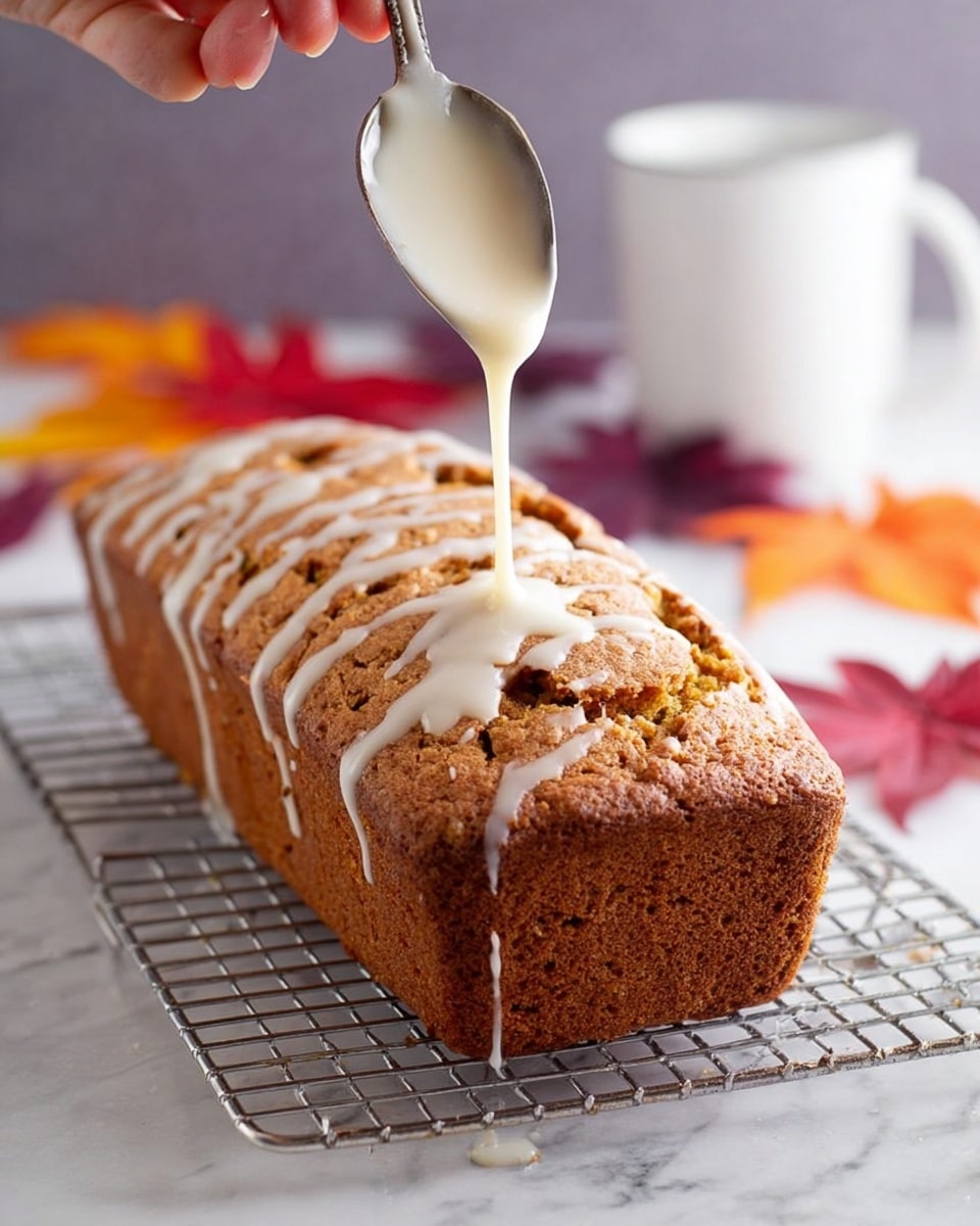 A loaf cake with a brown, slightly rough texture sits on a metal cooling rack over a white marbled surface. The cake is covered with white glaze that drips slowly down the sides creating smooth, shiny streaks. On top, small pieces of chopped walnuts are scattered unevenly, adding a rough, crunchy contrast to the smooth glaze and soft cake. In the background, blurry warm orange and red flowers add a soft, colorful touch but do not distract from the cake. photo taken with an iphone --ar 4:5 --v 7