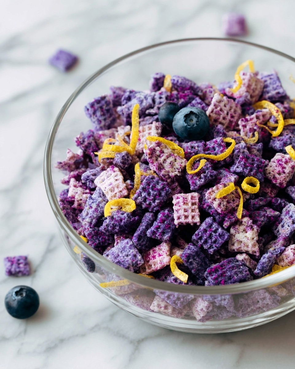 A clear glass bowl sits on a white marbled surface filled with purple square cereal pieces that have a waffle texture. Mixed in are darker purple clusters that appear crunchy and crumbly. Scattered thin yellow zest curls add bright contrast on top, and two whole blueberries rest near the edge of the bowl. The mix has a fresh, colorful look with a variety of textures. photo taken with an iphone --ar 4:5 --v 7